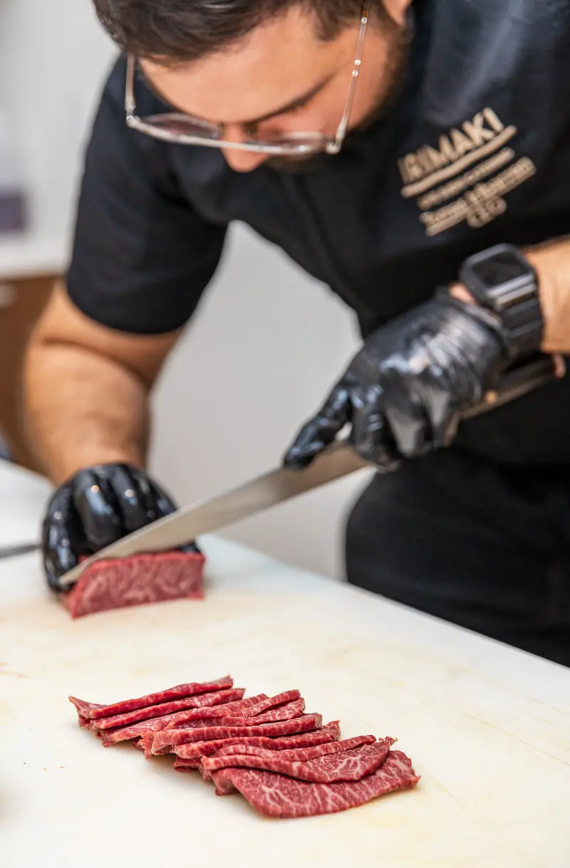 A chef slicing wagyu beef