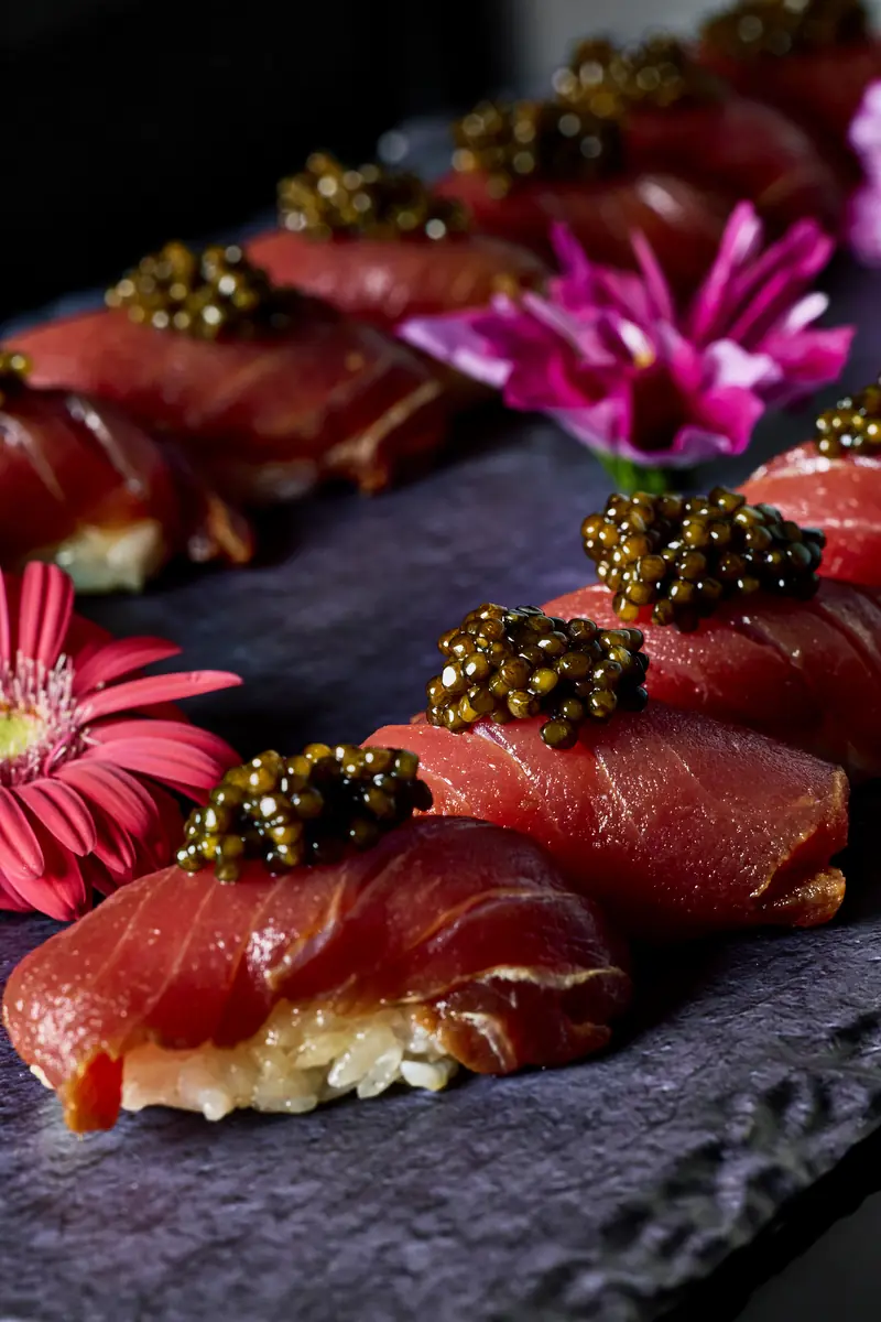 Otoro nigiri topped with caviar on slate